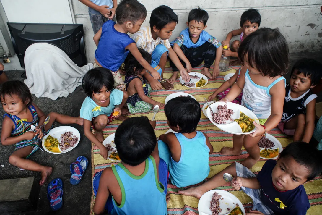 Children eating food in the Philippines
